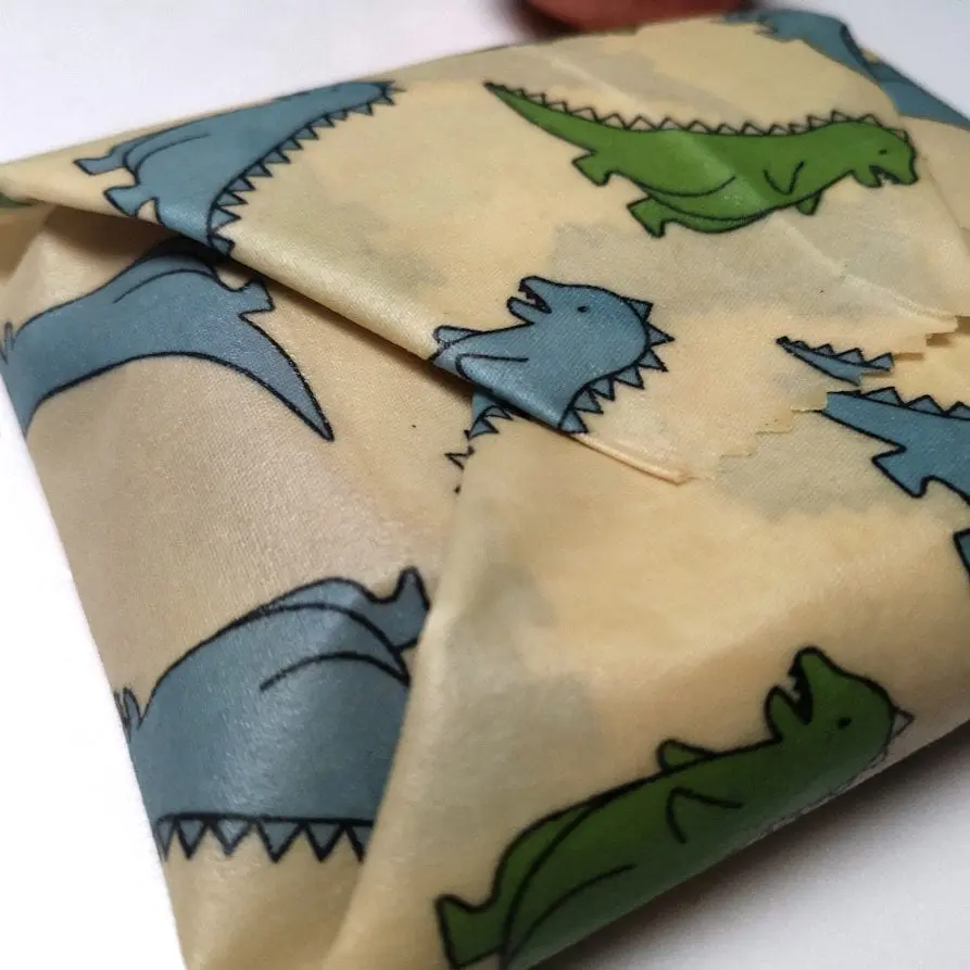 Closeup image of beeswax wrap with dinosaur pattern