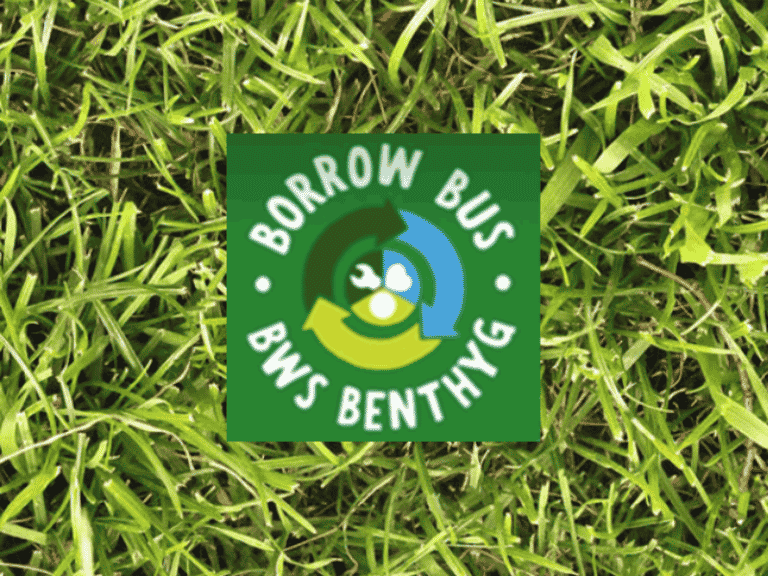 Borrow Bus logo on background of grass.