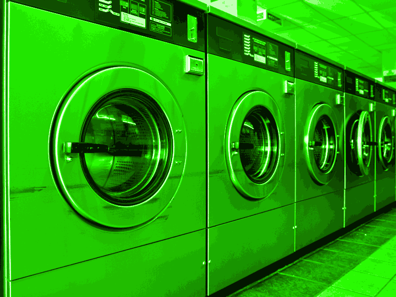 Commercial washing machines, all coloured green.