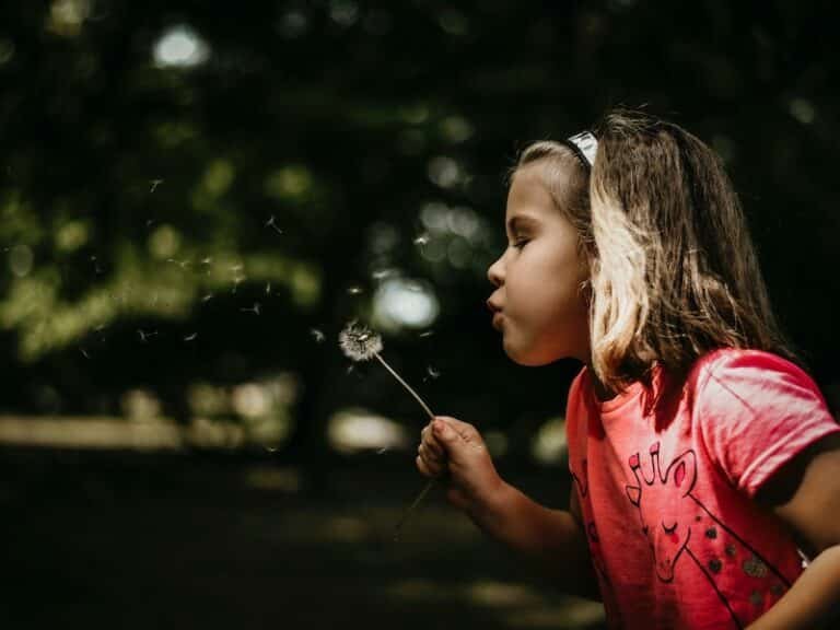 Girl blowing a dandelion - don't just wishcycle your waste away.