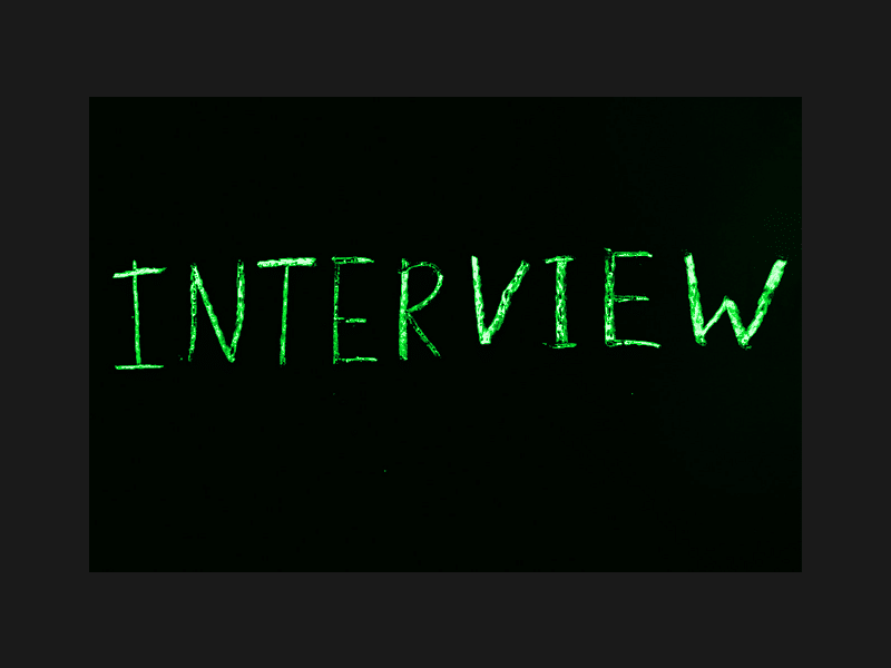 The word Interview written in green on black background.
