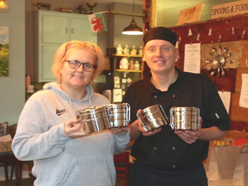 Tiffinn tins for Naked Takeaway scheme shown by staff at Spoons and Forks, Mold